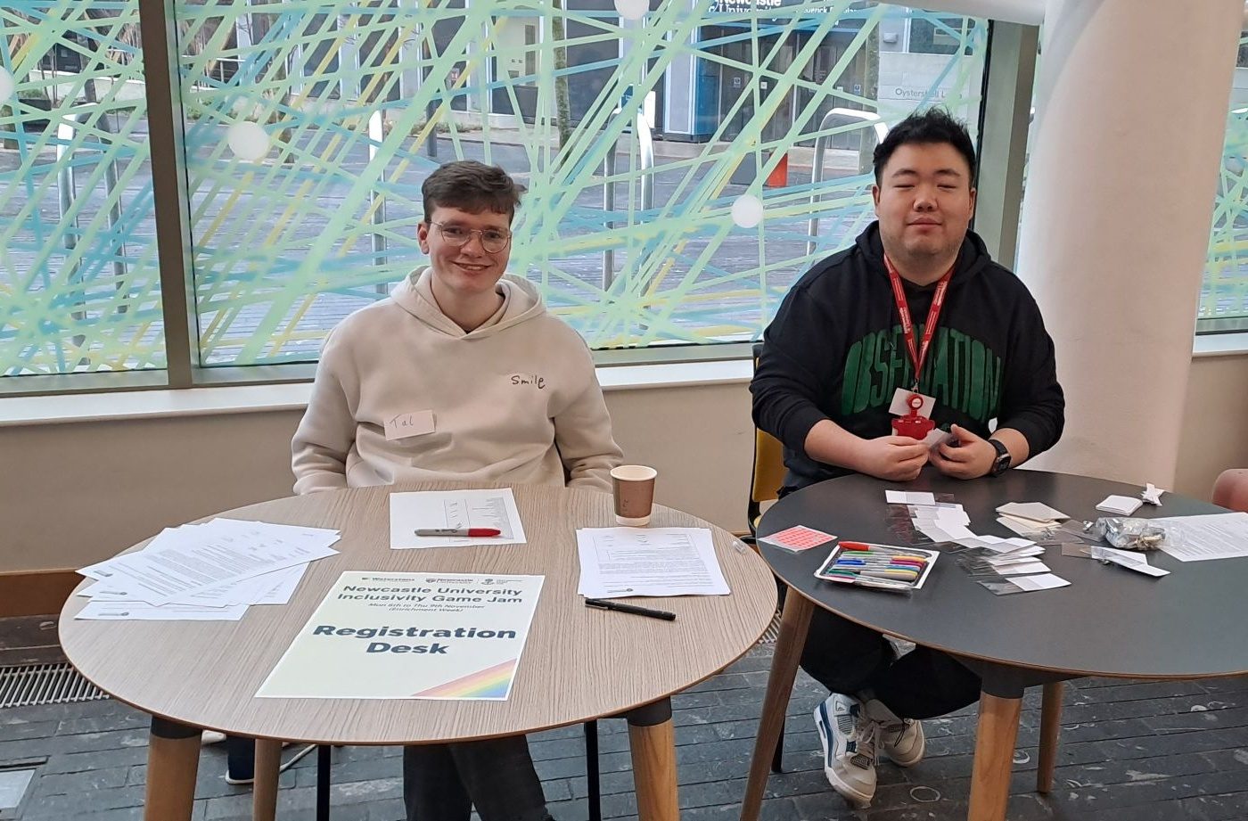 Tal running the registration desk at Newcastle University's Inclusivity Game Jam