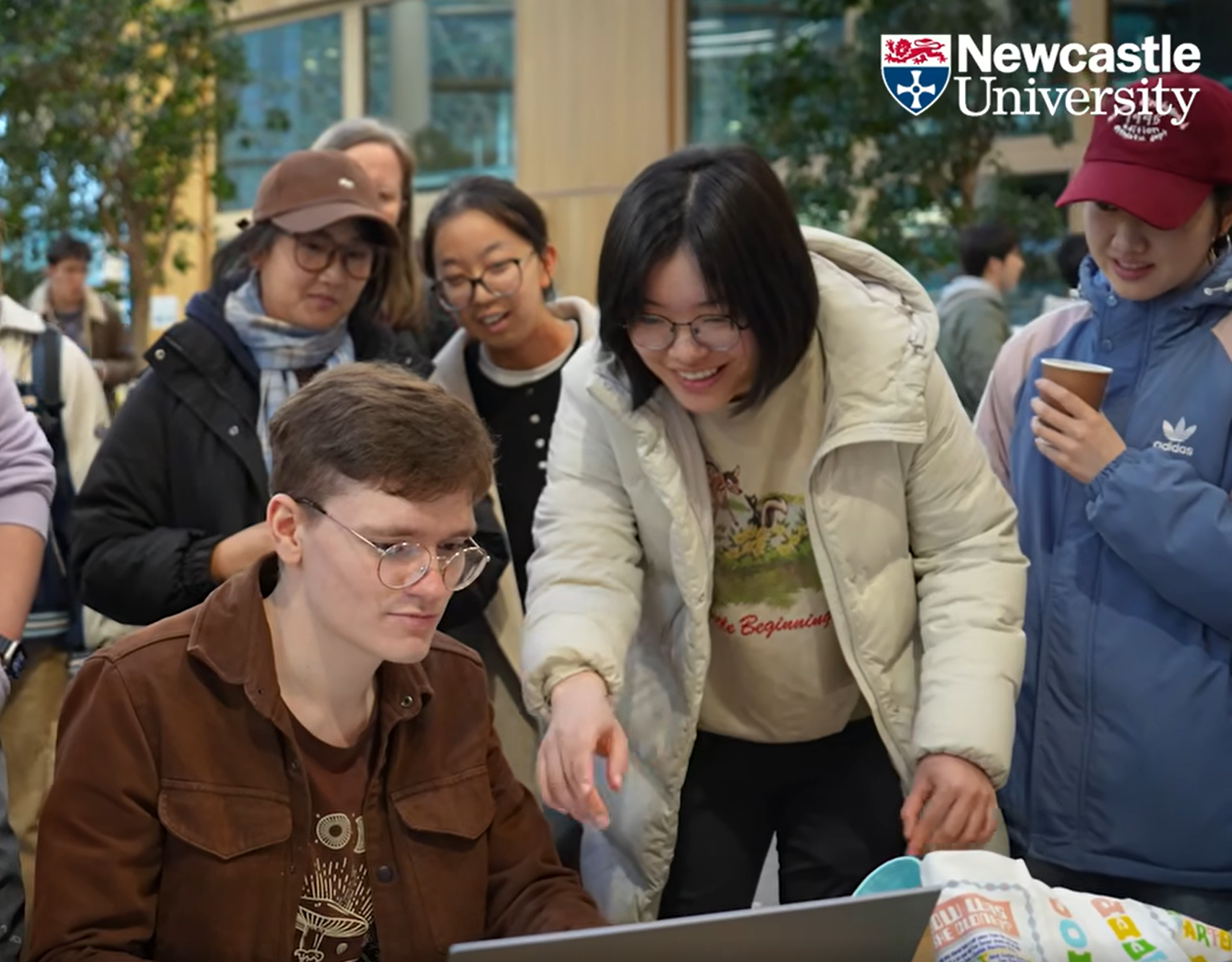 Pointing out a bug on screen with students at a Newcastle University game jam